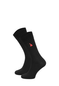 Czarne bawełniane skarpetki z prążkowanymi ściągaczami, z małym czerwonym logo po boku. Gładka tekstura i długość do pół łydki.