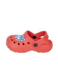 Red synthetic clogs with a blue graphic patch featuring a character, ventilation holes, raised sole, and black button accents.