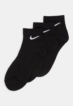 Zwarte katoenen crew sokken in een verpakking van drie, met een witte Nike-logo aan de zijkant, ribbelstructuur aan de bovenkant en een naadloze teen.
