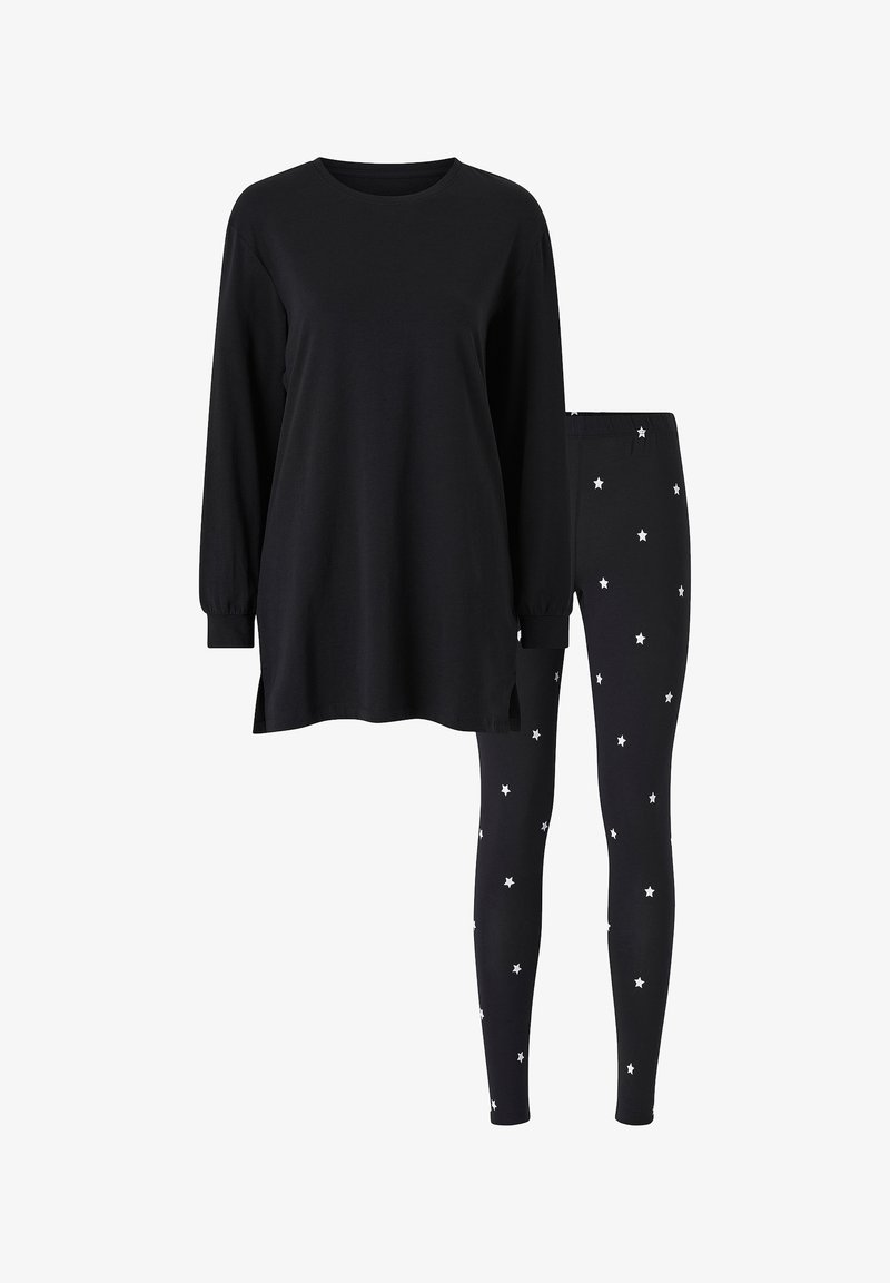 Black long-sleeve top with side slits paired with black leggings featuring white star pattern. Soft material, relaxed fit, simple design.