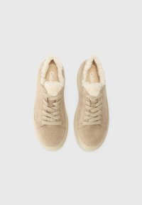 Beige suede sneakers with plush, cream-colored lining, featuring traditional lacing, a rounded toe, and a beige rubber sole.