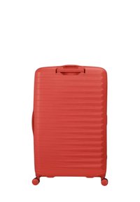 Valigia rigida rossa con superficie testurizzata, caratterizzata da scanalature verticali e maniglia superiore, montata su quattro ruote per la mobilità.
