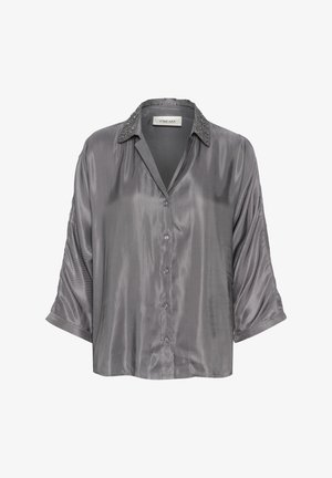 Pelēks satīna krekls ar apkakles dekoltē, rotātiem elementiem apkaklē un brīvu piegriezumu. Iespējas pogu aizdare un īsas, sarullētas piedurknes.