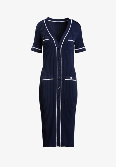 Jūras jūpējiem ar īsām piedurknēm, balta apmalē pa malām, ar pogu aizdari un divām priekšējām kabatām ar pogām.