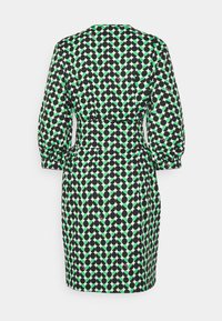 Kortärmad klänning med en figursydd midja, med ett mönster av färgglada prickar i grönt, svart och lila på en ljus bakgrund.