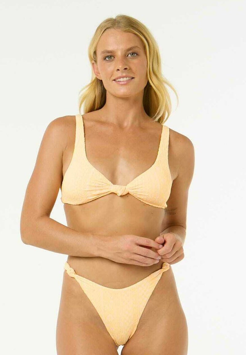 Yellow bikini set featuring a textured bralette with a knotted front, and low-rise bottoms with side knots. Soft fabric and minimal coverage.