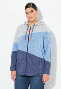 Šedá, modrá a námořnická mikina s kapucí na zip s designem v několika barvách; má přední zip, kapuci se šňůrkou a boční kapsy.