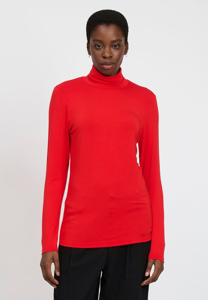 Rotes langärmliges Rollkragenoberteil aus glattem Stoff, mit figurnahem Design und dezenten Steppdetails am Saum.