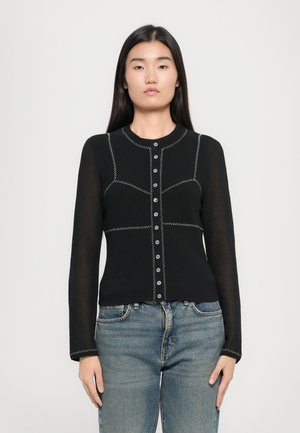Black ribbed cardigan with long sleeves, round neck, and white stitching. Front button closure, fitted design, and textured fabric.