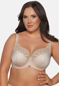 Reggiseno in tessuto nude liscio con dettagli in pizzo floreale lungo il bordo superiore; dotato di struttura con coppe sagomate e spalline larghe.
