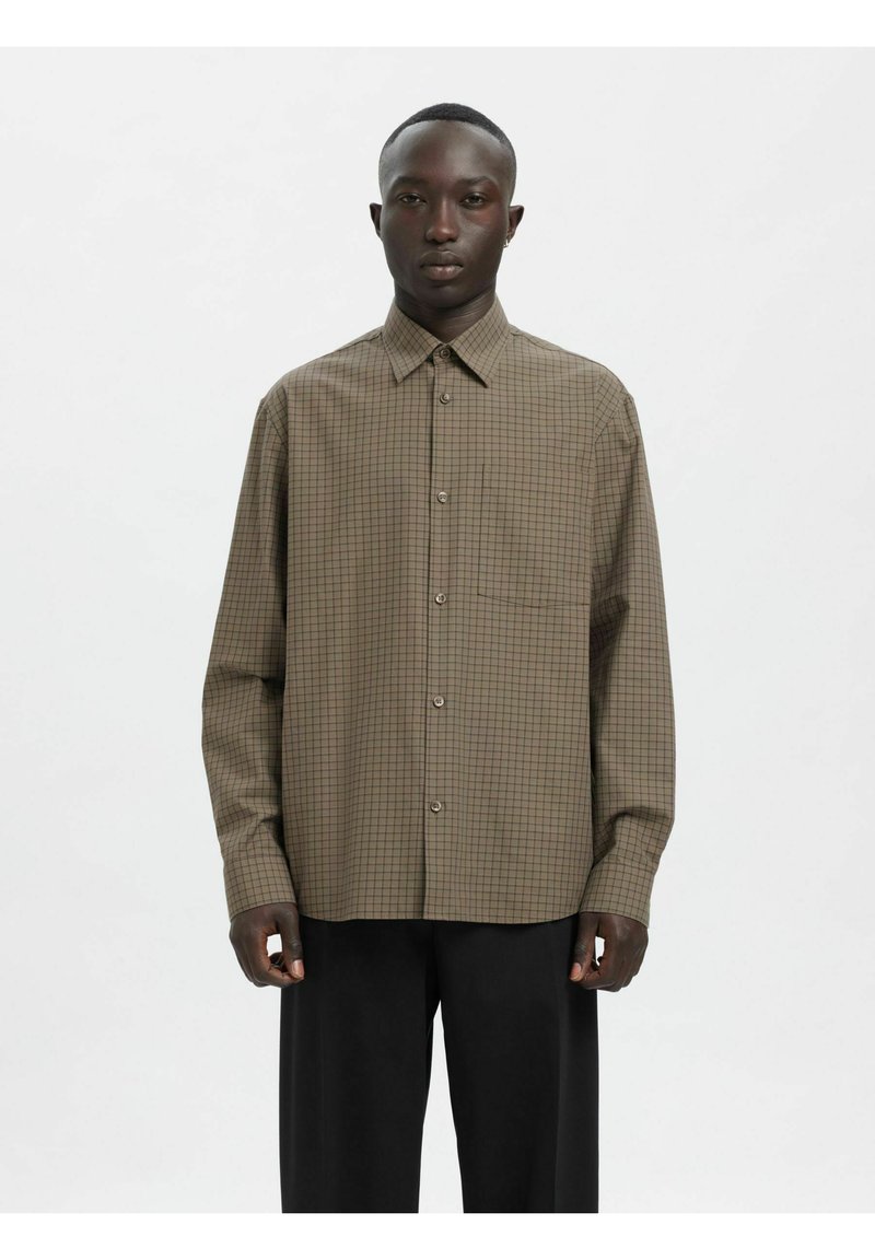 Brun rutete skjorte laget av lett stoff, med klassisk krage, lange ermer, knappestolpe og en brystlomme foran.