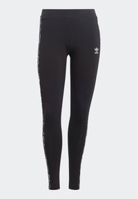 Svarta tajta leggings med leopardmönstrade sidostripes och en vit Adidas-logotyp på övre vänstra låret mot en enkel grå bakgrund.