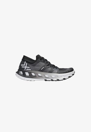 Zapatilla deportiva negra y gris con suela acolchada blanca y parte superior de malla transpirable, vista de lado sobre un fondo blanco.