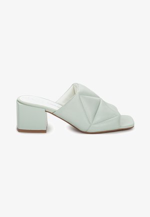 Light green leather mules with a folded design, open-toe, and a square block heel. Smooth texture with subtle stitching details.