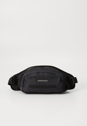 Black fabric waist bag featuring multiple zippered compartments, adjustable strap, and logo on the front. Smooth texture with a minimalist design.