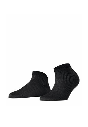 Paire de chaussettes noires pour cheville avec paillettes discrètes et texture côtelée, présentées de profil et par le dessous sur fond blanc.
