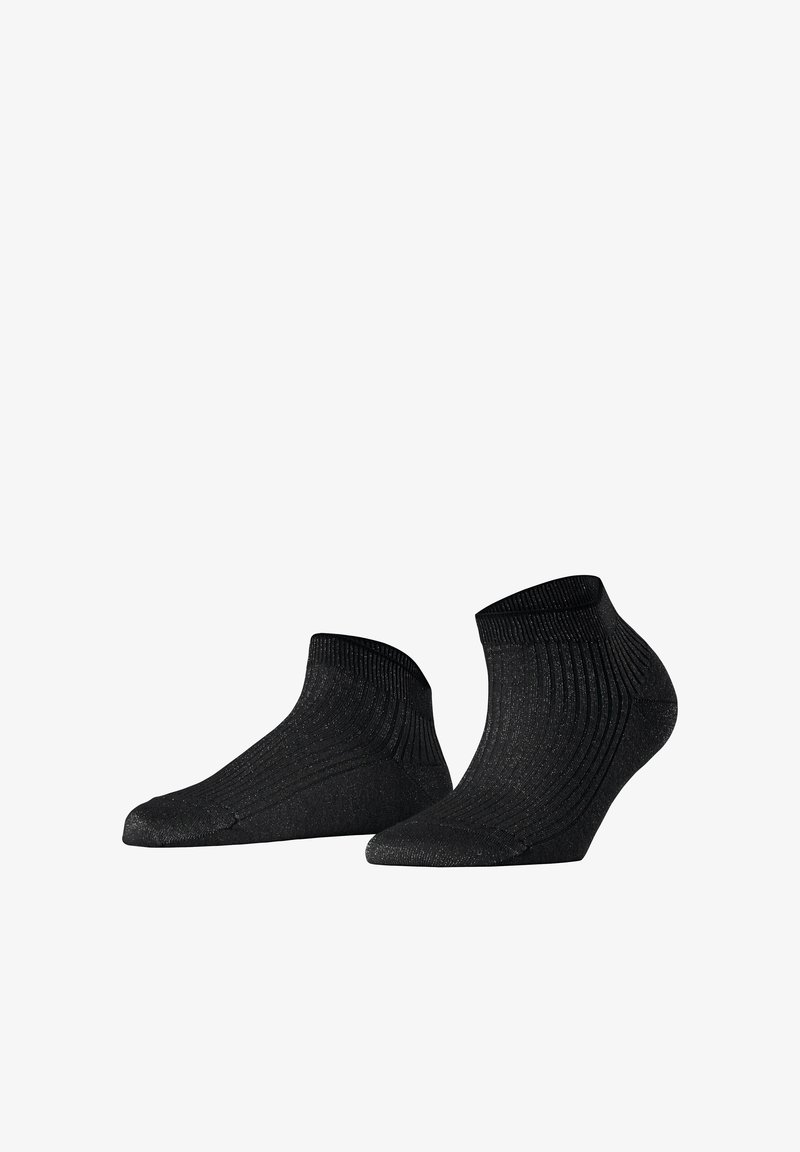 Paire de chaussettes noires pour cheville avec paillettes discrètes et texture côtelée, présentées de profil et par le dessous sur fond blanc.