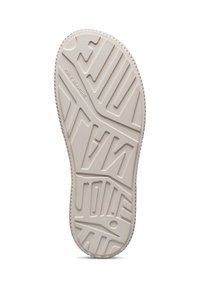 Sole di una scarpa, gomma leggera beige chiaro con scanalature e modelli testurizzati. Marchio impresso e un dettaglio circolare vicino alla punta.