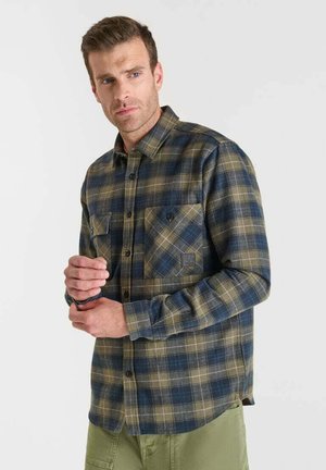 Flanellen shirt in een groen, blauw en beige ruitpatroon. Voorzien van een knoopsluiting aan de voorkant, twee borstzakken en een gestructureerde stof.