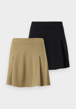 Dva preklopljena A-kroja suknje, jedna bež i jedna crna, prikazane na bijeloj pozadini.