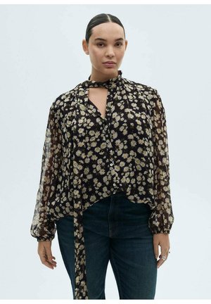 Zwarte bloementop met lange, transparante mouwen, voorzien van een halsband en knoopsluiting aan de voorkant. Klein geel en wit bloemenpatroon door het geheel.