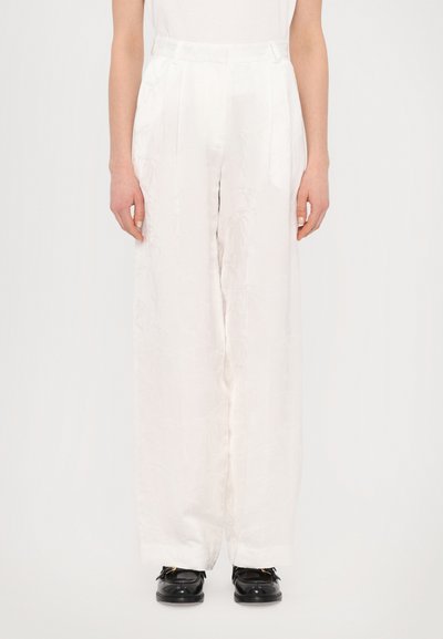 White, wide-leg trousers with a textured finish and subtle floral pattern. Features a high waist with pleats and a smooth, elegant drape.