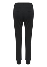 Svarta sweatpants med en mjuk textur, smalnande ben och ett elastiskt midjeband med tre horisontella ränder på baksidan.