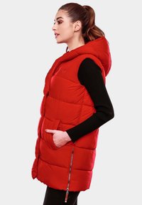 Red padded vest with a hood, featuring a zippered side pocket and a front button closure. Made of shiny, insulated fabric with quilted design.