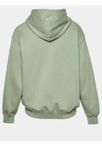 Groene hoodie met een ruime capuchon, geribbelde mouwen en tailleband. Gemaakt van zachte stof, met een gladde textuur en een ontspannen pasvorm.
