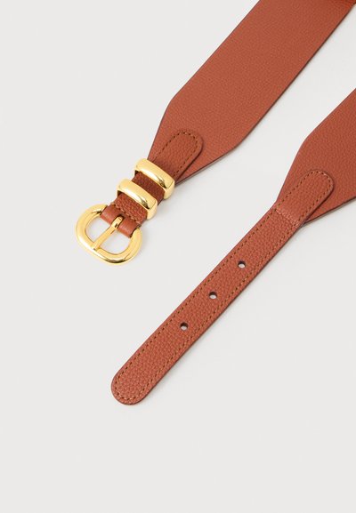 Καφέ δερμάτινη ζώνη με υφή, με γυαλιστερή χρυσή αγκράφα και δύο χρυσούς κρίκους σε ανοιχτό φόντο.
