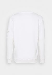 Felpa bianca con scollo rotondo, maniche lunghe, polsini a costine e dettaglio con tasca sul braccio sinistro. Tessuto dalla trama liscia.