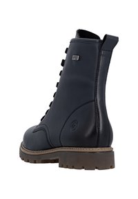 Schwarze Leder-Ankle-Boots mit strukturierter Oberfläche, auffälligen Schnürsenkeln und robuster Gummisohle. Mit einer Zuglasche und einem Markenlogo an der Seite.