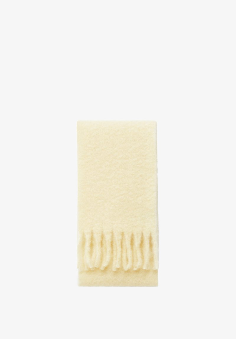 Wool blanket in cream color, featuring a soft texture with fringe detailing along one edge, folded neatly.