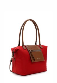 Red nylon handbag with brown leather accents, featuring two handles, a detachable strap, and a front zippered pocket.