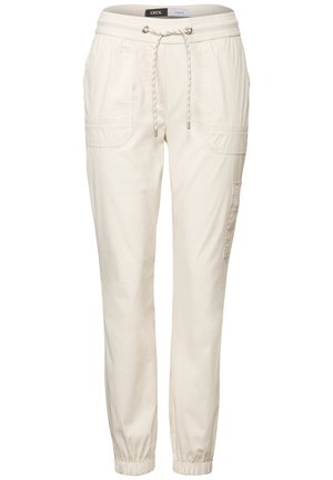 Helle beige Baumwollmischungshosen mit einem elastischen Bund, Kordelzugdetails, Seitentaschen und elastischen Bündchen an den Knöcheln.