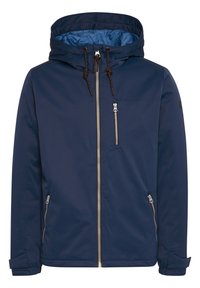 Giacca impermeabile blu navy con cappuccio, dotata di zip argentate, polsini elasticizzati e una fodera interna di un blu a contrasto.