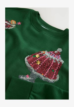 Roheline sweatshirt, millel on punase, roosa ja hõbedase peegelpinnaga muffinidisain koos väikeste lilledega kaunistuste detailidega. Pehme kangas, soonikkoes krae ja varrukad.