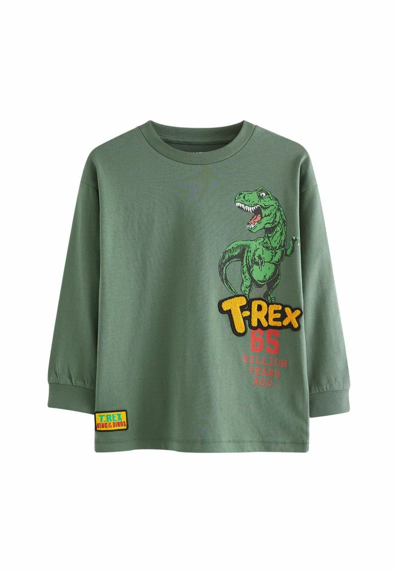 Grünes Langarm-T-Shirt mit einem T-Rex-Graphic in Grün und Gelb, mit rotem Text "VOR 65 MILLIONEN JAHREN" und einem Logo-Patch.