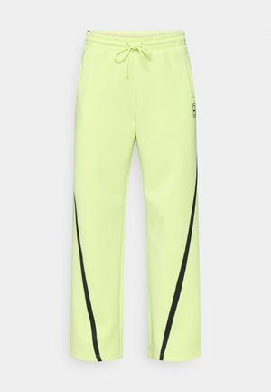 Laime rohelised sportpüksid elastse vöörihma, nööriga ja mustade diagonaalsete detailidega. Valmistatud siledast, venivast materjalist.