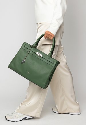 Green textured leather handbag with dual top handles, featuring a silver hardware closure and a decorative key charm.