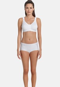 Weißer BH mit Frontverschluss und verstellbaren Trägern, kombiniert mit weißen Shorts mit Netzeinsätzen. Glatte Textur, schlichtes Design.