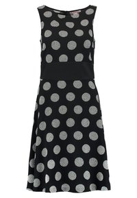 Musta mekko valkoisilla pilkuilla, jossa on istuva yläosa ja levenevä helma. Valmistettu kuvioidusta kankaasta, jossa on pyöreä pääntie ja vetoketju selässä.