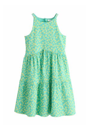 Ein ärmelloses, türkisfarbenes Kleid mit Stufendesign, gelben Polka-Dots und einem gerafften Oberteil, hergestellt aus leichtem Stoff.