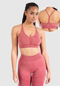 Stofroze sportbeha met een geplooid voorpand, brede schouderbanden en een racerback ontwerp. Gladde stof met een subtiele textuur, gecombineerd met bijpassende leggings.