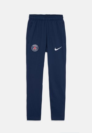 Joggers azul-marinho com um cós elástico, bolsos laterais, um logo de Paris na coxa esquerda e um swoosh branco da Nike na direita.