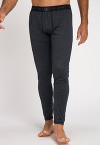 Herren schwarze Leggings aus weichem stretchigem Material, mit einem komfortablen Bund mit Markennamen. Die Seitennähte haben eine glatte Verarbeitung.