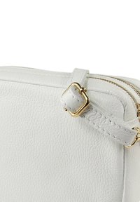 White textured leather bag with a gold-toned buckle and zipper accents. Features a simple rectangular design and contrasting stitching.