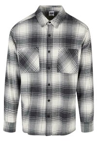 Flannel skjorte i sort, hvid og grå ternet mønster. Har to forlommer, knaplukning og lange ærmer med knapmanchetter.