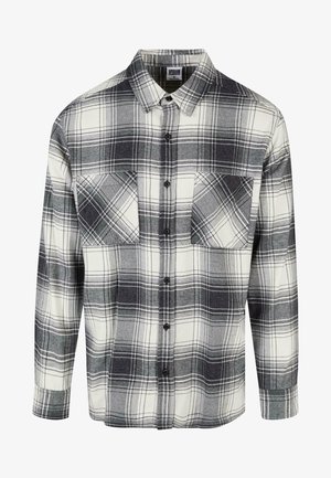 Cămașă din flanel în carouri negre, albe și gri. Include două buzunare frontale, închidere cu butoane și mâneci lungi cu manșete cu buton.