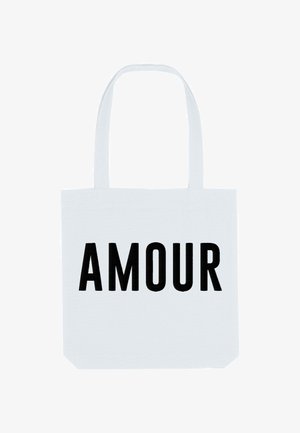 Borsa tote bianca in cotone con la parola "AMOUR" in grassetto nero. La borsa dispone di due manici robusti per il trasporto.